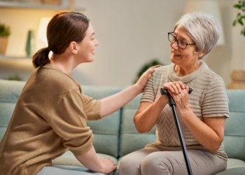 A female talking to an elderly woman