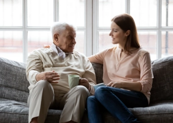 An elderly man and a female talking to each other