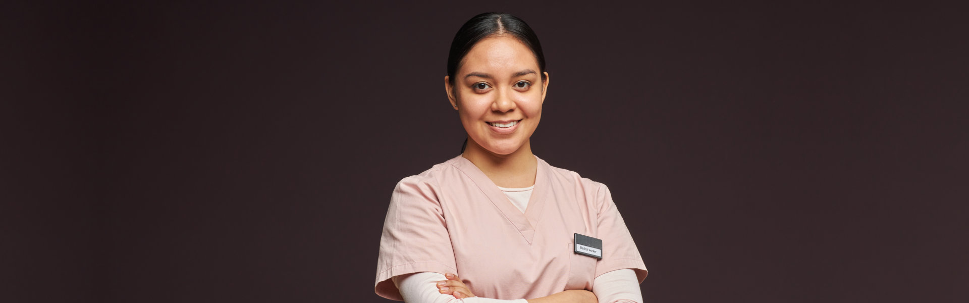 A female caregiver smiling