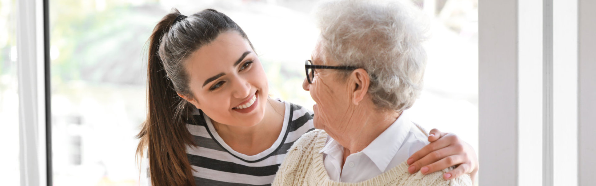 A female and an elderly woman looking at each other